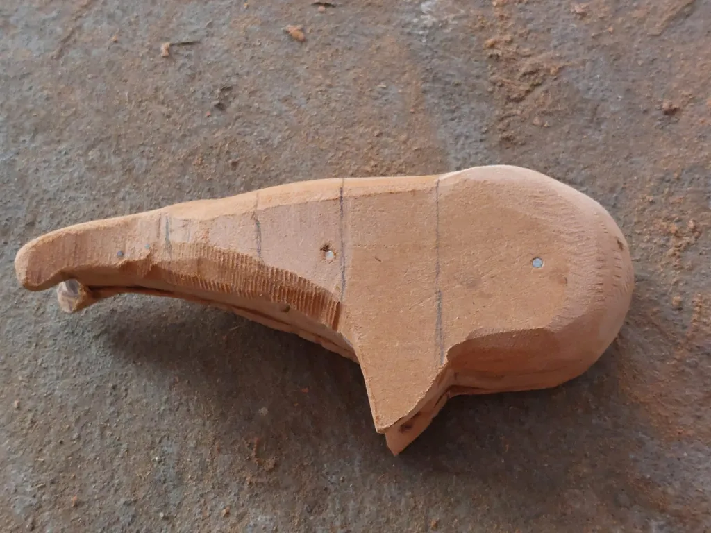 Raw wooden whale sculpture showing natural grain and craftsmanship
